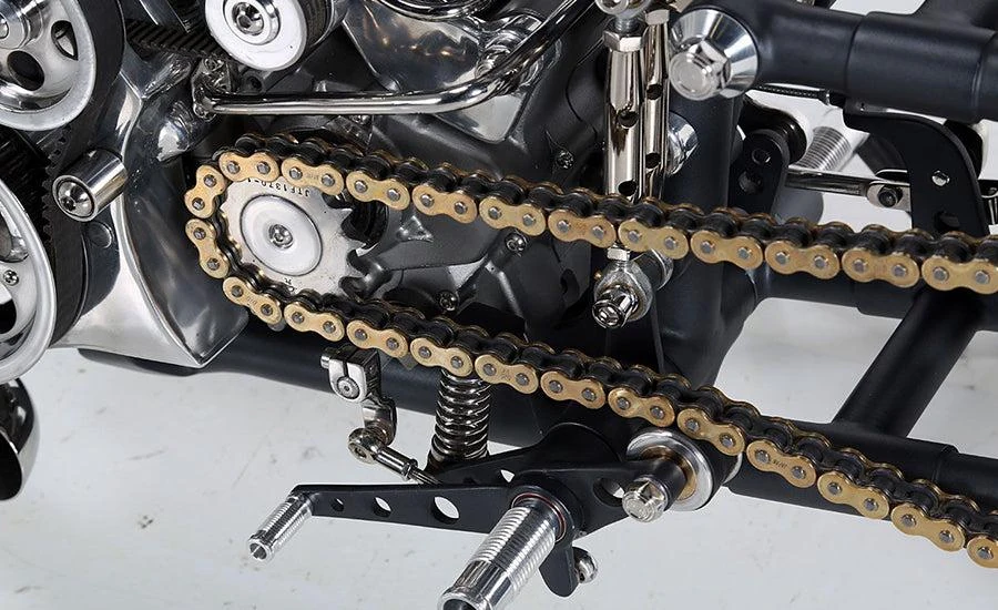 Motorcycle drive chain and front sprocket installed beside the engine